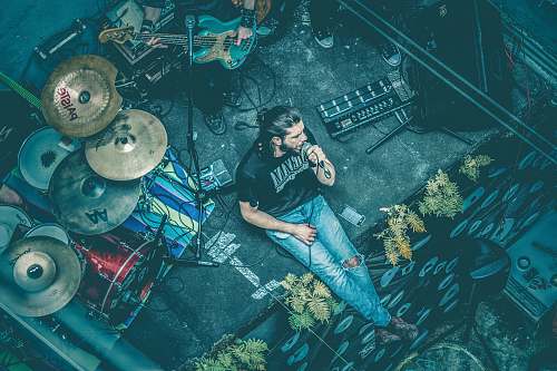 portugal man sitting while singing beside instruments man